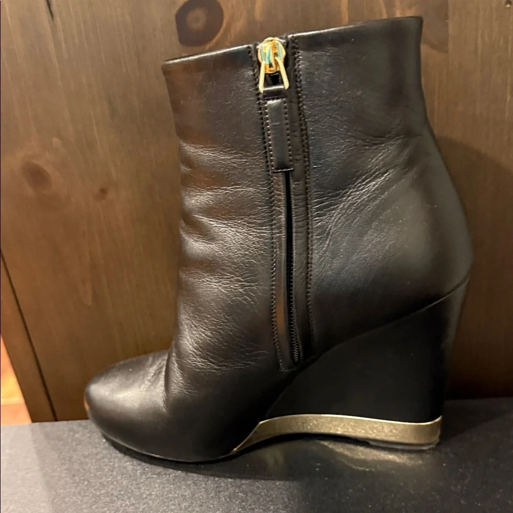 CHANEL Black Leather Wedge Boots with Gold Accent
